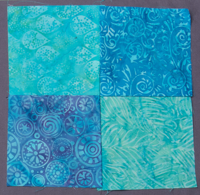 4-patch block with light and dark blue-green batik fabrics