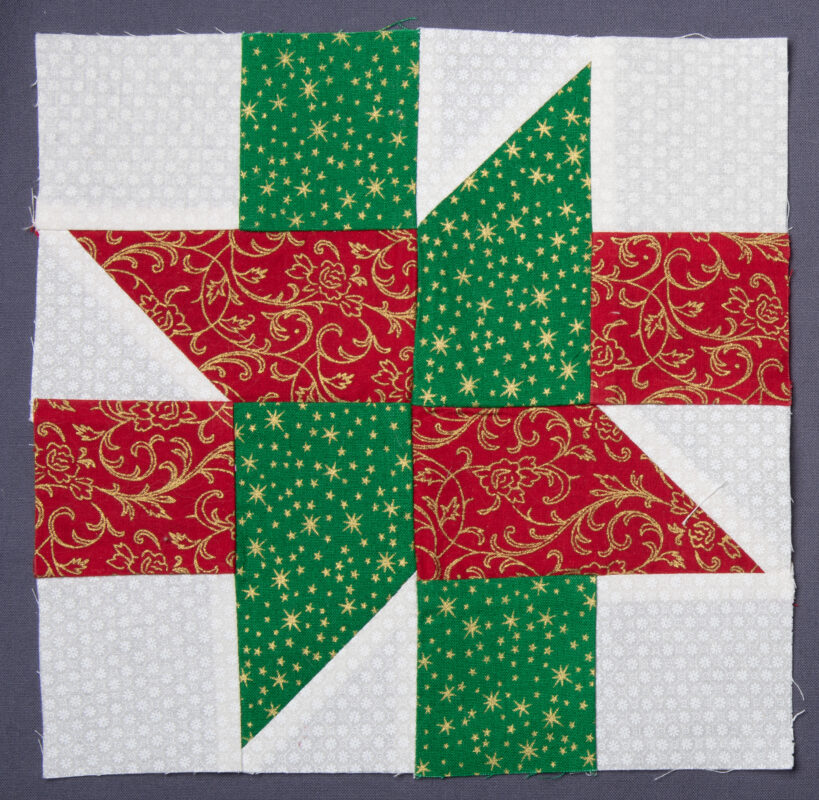 A block that looks like a red and green bow on a Christmas present.
