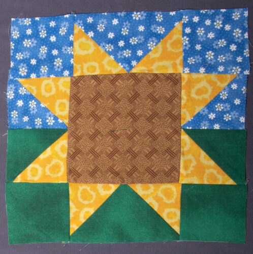 This 8" variable star was created to honor and support Ukraine. The middle block represents the soil, the yellow stars their wheat, and the blue and green the sky and ground.