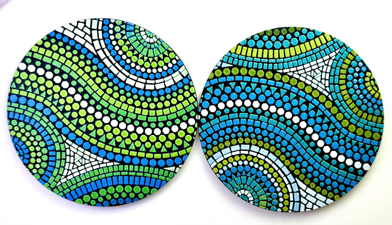 Blue and gold coasters on black background with white accents.